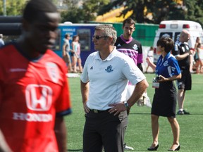 Edmonton head coach Colin Miller (centre) looks on as Indy players celebrate their win at the conclusion of a NASL soccer game between FC Edmonton and the Indy Eleven at Clark Stadium in Edmonton, Alta., on Sunday, July 27, 2014. The Eddies lost 0-1 in extra time. Ian Kucerak/Edmonton Sun/QMI Agency