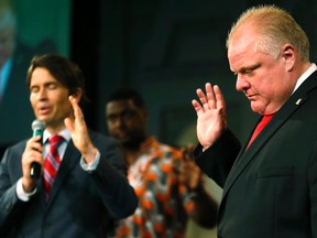 Lead Pastor Nathan Thurber prays with his congregation for Mayor Rob Ford at the Toronto International Celebration Church on Sunday, July 27, 2014. (Craig Robertson/Toronto Sun)