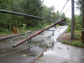 Trees and power lines came down near Grand Bend as a severe storm moved Sunday evening through Lambton Shores. Crews were at work Monday cleaning up the damage and working to restore electricity to more than 4,000 homes. (LYNDA HILLMAN-RAPLEY, QMI Agency)