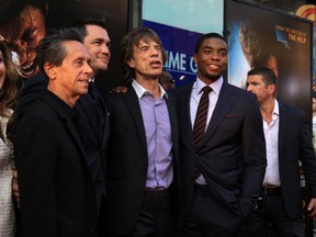 Brian Grazer, second from left, Mick Jagger, second from right, and Chadwick Boseman, right at the New York premiere of "Get On Up" at The Apollo Theater, July 21, 2014. (Michael Carpenter/WENN.COM)