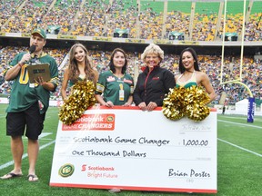 From left: In stadium host Chris Sheets, Eskimos Cheer Team member Katie, Game Changer nominee Tara Baker, Scotiabank Game Changer representative Terry Sharun and Eskimos Cheer Team member Chelsea present Baker with a cheque for $1,000 during the Edmonton Eskimos home game on July, 24.
Barry Kerton | Whitecourt Star