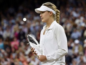 Eugenie Bouchard of Canada holds the runner up trophy after being defeated by Petra Kvitova of Czech Republic at their women's singles final tennis match at the Wimbledon Tennis Championships in London July 5, 2014. (REUTERS)