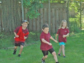 Playing a game of soccer are, from left, Josh French, Hayden Nicholson, and Calla Britton. KRISTINE JEAN/MITCHELL ADVOCATE
