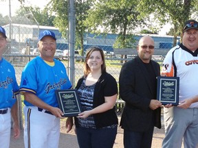 Mitchell Minor Sports President Mark Moore (third from right) and Secretary Trish McNaughton formally recognized the contributions to their sports programming of two Mitchell slo-pitch teams, the Grizzlies and Coyotes, last week. Representing the Grizzlies are Bill Appleby (left) and Bill Walt, and thanking them for their major financial contributions over the years generated through their Cornfest tournament in mid-August. Representing the Coyotes are Jim Scott (right) and Jamie Daum, as their team was thanked for their financial contribution to minor sports over the years, generated through their tournament in June. ANDY BADER/MITCHELL ADVOCATE