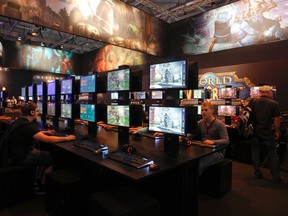 Visitors play "World of Warcraft" during the Gamescom 2013 fair in Cologne Aug. 21, 2013. REUTERS/Ina Fassbender