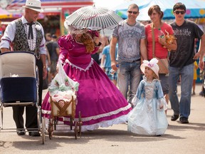 Ken and Corinne Kalakalo take their grand-daughter Jayden,3, for a stroll Sunday afternoon on the final day of K Days in Edmonton, Alberta on July 27th, 2014.  Chad Steeves /Edmonton Sun /QMI Agency
