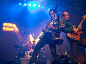 Rivers Cuomo of Weezer, left, is joined by bassist Scott Shriner, at the front of the stage as they rocked the park on the weekend. (CRAIG GLOVER/The London Free Press)