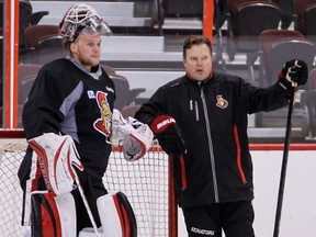 Senators goalie coach Rick Wamsley (right) chats with Robin Lehner during a practice last season. Maybe Lehner will let Wamsley stay at his place for awhile! (Ottawa Sun File)