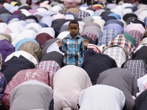 A young boy stands out during a prayer at Eid-ul-Fitr Festival at the Metro Convention Centre on Monday, July 28, 2014. (Craig Robertson/Toronto Sun)