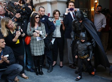 REFILE - ADDING SURNAME OF BATKID - Five-year-old leukemia survivor Miles Scott, dressed as "Batkid" and Batman leave a bank after they apprehended The Riddler as part of a day arranged by the Make- A - Wish Foundation in San Francisco, California November 15, 2013. The young cancer survivor was treated to various super hero scenarios including receiving a commendation at San Francisco City Hall.   REUTERS/Stephen Lam