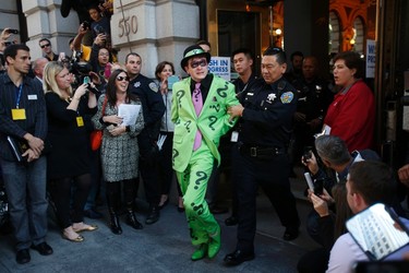 The Riddler is taken away by a San Francisco Police officer after being apprehended by five-year-old leukemia survivor Miles Scott, dressed as "Batkid" and Batman (not pictured) as part of a day arranged by the Make- A - Wish Foundation in San Francisco, California November 15, 2013. The young cancer survivor was treated to various super hero scenarios including receiving a commendation at San Francisco City Hall.   REUTERS/Stephen Lam