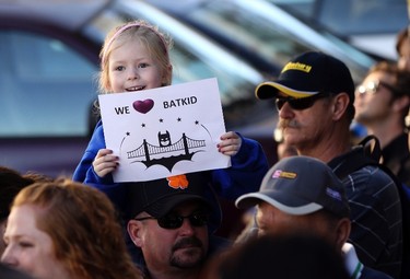 Kayla Fry holds a sign as she waits to see five-year-old leukemia survivor Miles, aka "Batkid", as part of a day arranged by the Make-A-Wish Foundation in San Francisco, California November 15, 2013. Miles will be treated to various super hero scenarios including receiving a commendation at San Francisco City Hall. REUTERS/Robert Galbraith