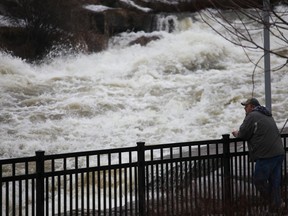 A bystander observes the rushing Napanee River on April 8, the same day Quinte Conservation issued a flood warning for the Napanee River.