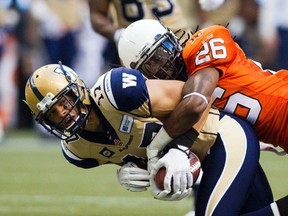 B.C Lions Cord Parks tackles Winnipeg Blue Bombers' slotback Nick Moore during the first half of their CFL football game in Vancouver last Friday. Moore suffered a foot injury in the win and won't play Thursday in Hamilton. (REUTERS/Ben Nelms)