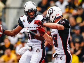 RedBlacks' Marcus Henry (left) celebrates his touchdown with teammate Matt Carter against the Hamilton Tiger-Cats. The RedBlacks play Saskatchewan Saturday at 7 p.m.  
(Mark Blinch/Reuters)