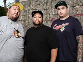 DJ NDN (right) sports a "Caucasians" shirt in this promotional photo of the Canadian hip hop trio A Tribe Called Red. (Files)