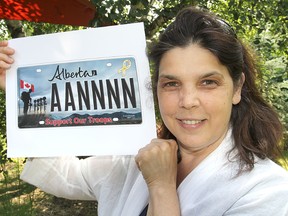Kingston artist Silvia Pecota holds a copy of her image commemorating the deaths of four soldiers in Afghanistan in 2002, which is now appearing on licence plates in Alberta. TUES., JULY 29, 2014 KINGSTON, ONT. MICHAEL LEA\THE WHIG STANDARD\QMI AGENCY