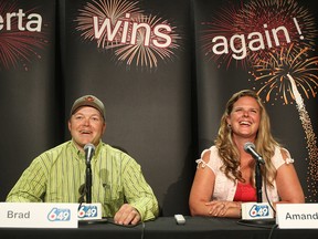 Bradley Kelly and his wife Amanda Kelly speak to the media about their $18 million Lotto 6/49 win during a press conference, in St. Albert Alta., on Tuesday July 29, 2014. The Kelly's had the winning ticket for the June 25, 2014 draw. David Bloom/Edmonton Sun