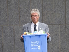 Jay Sanford, right, says Londoners love the Big Blue recycling bin and its introduction has saved money and increased participation in recycling. (Free Press file photo)