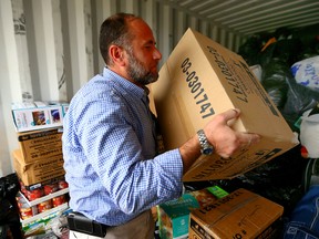 Tarif Awa helps load donated supplies destined for Syria. (DAVE ABEL, Toronto Sun