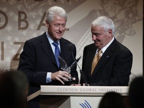 Former U.S. President Bill Clinton presents philanthropist Tom Golisano with an award at the Clinton Global Citizen Award ceremony marking the culmination of the Clinton Global Initiative in New York September 23, 2010. (REUTERS/Lucas Jackson)