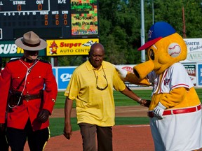 Canadian and former Major League Baseball player Ferguson Jenkins interacts with Winnipeg Goldeyes mascot Goldie during the 2014 American Association All-Star Game at Shaw Park in Winnipeg, Man., on Tues., July 31, 2014. (Brook Jones/QMI Agency)