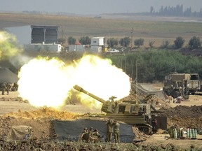An Israeli canon fires a 155mm shell towards targets in the Gaza Strip from their position along the border between Israel and the Hamas-controlled Gaza Strip on July 29. (AFP PHOTO)