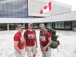 JOHN LAPPA/THE SUDBURY STAR/QMI AGENCY Steve Hartwig, right, Scott McFarlane, left, and Jason McKenzie are marching across Canada to raise awareness about PTSD. The men stopped in Sudbury, ON. on Tuesday, July 29, 2014.