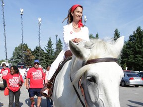 Mayoral candidate Sarah Thomson rides in on a horse at Ford Fest on Friday, July 25, 2014. (CRAIG ROBERTSON/Toronto Sun)
