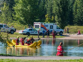 Fire and EMS crews search a pond in Whitecourt's Rotary Park after a 19-year-old male was reported missing at around 4 p.m. on Tuesday, July 29. Divers searched the pond until 11 p.m. when approaching thunderstorm forced officials to call off the search for the night. (Bryan Passifiume/QMI Agency)