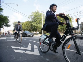 Denzil Minnan-Wong unveils new bike lanes on Adelaide St. with councillors Mike Layton and Ceta Ramkhalawansingh and Stephen Buckley, general manager of transportation services for the City of Toronto on Wednesday, July 30, 2014. (STAN BEHAL/Toronto Sun)