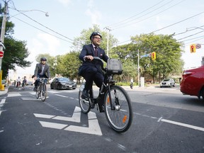 Denzil Minnan-Wong unveils new bike lanes on Adelaide St. with councillors Mike Layton and Ceta Ramkhalawansingh and Stephen Buckley, general manager of transportation services for the City of Toronto on Wednesday, July 30, 2014. (STAN BEHAL/Toronto Sun)