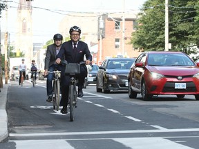 Denzil Minnan-Wong unveils new bike lanes on Adelaide St. with councillors Mike Layton and Ceta Ramkhalawansingh and Stephen Buckley, general manager of transportation services for the City of Toronto on Wednesday, July 30, 2014. (STAN BEHAL/Toronto Sun)