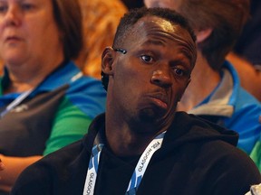 Usain Bolt of Jamaica reacts as he watches the netball match between Jamaica and New Zealand at the 2014 Commonwealth Games in Glasgow, Scotland, July 30, 2014. (REUTERS)