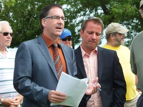 Windsor MP Brian Masse, left, made a stop in Sarnia on Wednesday to announce plans to table a bill aimed at invasive Asian carp. Jason McMichael of the Customs and Immigration Union, right, looks on. BRENT BOLES / THE OBSERVER / QMI AGENCY