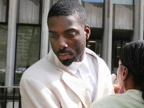 Alwayne Bigbywalks out of 361 University courthouse surrounded by family Wednesday July 30, 2014, after being released on bail for first-degree murder charges in the death of Andrea White. (Stan Behal/Toronto Sun)