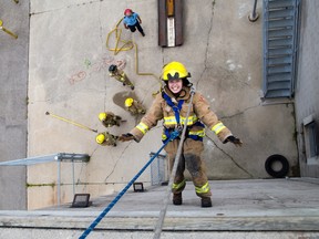 Drue Adams rappels down a wall at the firefighter training facility in London on Wednesday. She and 19 other teenage girls have been participating in Camp FFIT London this week to get a taste of what it's like to be firefighter. DEREK RUTTAN/ The London Free Press /QMI AGENCY