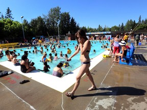 A large crowd enjoy the weather at Millcreek Pool in Edmonton, Alberta on July 30, 2014. The pool was so busy, lifeguards had to close down the deep end due to hazy water.  The filter system could not keep up and the lifeguards cannot see the bottom of the pool.  Perry Mah/Edmonton Sun