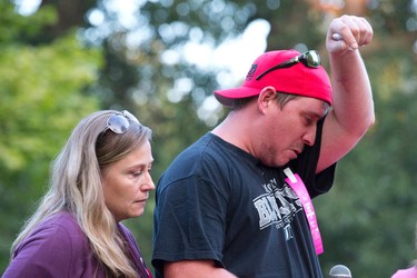 "Auntie" Carry McIntyre, left, stands by her cousin, Eric Hall, right, as he wipes tears from his eyes while talking about his daughter, Addison Hall, during a candle lit vigil in Greenway Park in London on Wednesday July 30, 2014.  Addison Hall was killed last Friday while walking in a south London Costco store with her mother when the family was struck by a car.
CRAIG GLOVER The London Free Press / QMI AGENCY