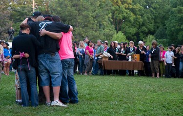 Family and friends of Addison Hall embrace at a candle lit vigil for the six-year-old girl in Greenway Park in London on Wednesday July 30, 2014.  Addison Hall was killed last Friday while walking in a south London Costco store with her mother when the family was struck by a car.
CRAIG GLOVER The London Free Press / QMI AGENCY