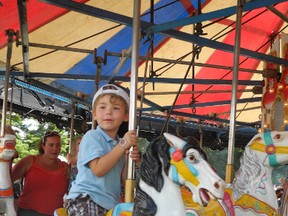 Four-year-old Jayden Price happily rode the carousel at the 2013 Williamstown Fair. The 2014 fair begins Aug. 8.FILE PHOTO/CORNWALL STANDARD-FREEHOLDER/QMI AGENCY