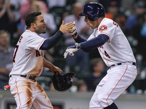 Houston Astros right fielder George Springer (right) is congratulated by second baseman Jose Altuve during a game earlier this season. (Troy Taormina-USA/TODAY Sports)