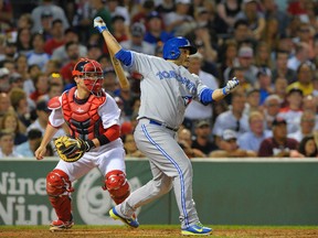 Toronto Blue Jays catcher Dioner Navarro (30) hits an RBI single during the fifth inning against the Boston Red Sox at Fenway Park on Jul 30, 2014 in Boston, MA, USA. (Bob DeChiara/USA TODAY Sports)