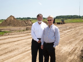 Milfred Hammerbacher of S2E Technologies, left, and Richard Sifton of Sifton Properties stand on land destined for a ``SMART? community which will eventually house 2,000 people. (DEREK RUTTAN/ The London Free Press)