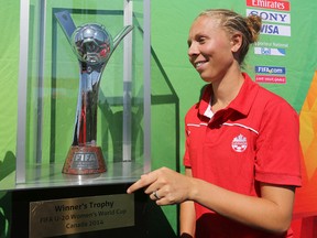 Canadian National Soccer Team member Brittany Baxter poses for a photo beside the FIFA U-20 Women's World Cup Canada 2015 Winner's Trophy during the FIFA Live Your Goals soccer camp at the Clareview Recreation Centre, 3804 - 139 Ave., in Edmonton Alta., on Sunday July 27, 2014. 200 young soccer players took part in the event. David Bloom/Edmonton Sun/ QMI Agency