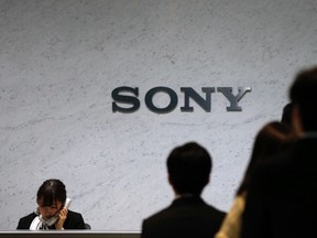 A receptionist speaks on a phone under a Sony Corp logo at the company's headquarters in Tokyo, in this file picture taken Feb. 6, 2014.     REUTERS/Toru Hanai/Files