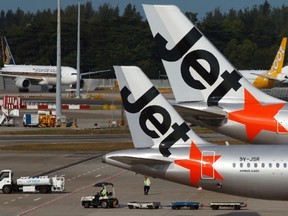 udget airline Jetstar aircrafts sit on the tarmac at Singapore's Changi Airport February 6, 2014. REUTERS/Edgar Su