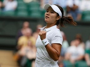 Li Na of China reacts after defeating Paula Kania of Poland in their women's singles tennis match at the Wimbledon Tennis Championships, in London June 23, 2014. (REUTERS/Stefan Wermuth)