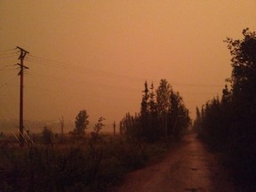 The smoke-filled sky turned orange just before a huge thunderstorm hit Yellowknife, Northwest Territories Wednesday night. (Sarah Elsasser/@SassoYK)