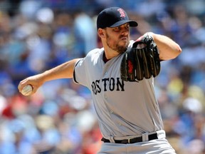 Boston Red Sox starting pitcher John Lackey delivers in the first inning against the Kansas City Royals during their MLB American League baseball game in Kansas City, Missouri August 11, 2013. (REUTERS/Dave Kaup)